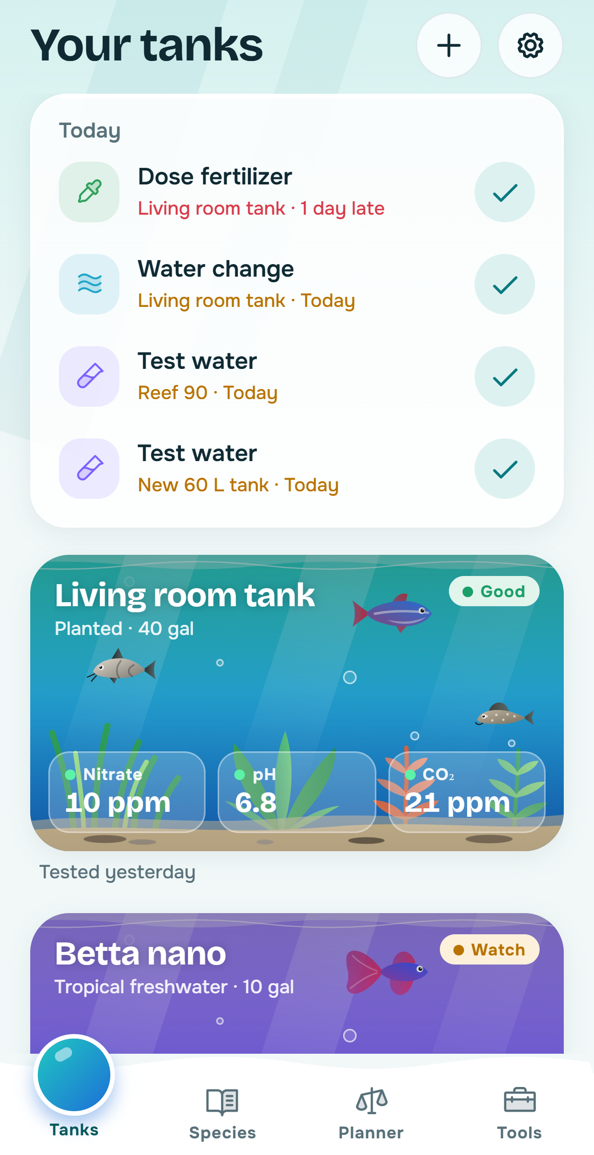 Guppi tanks screen with animated aquariums and water values